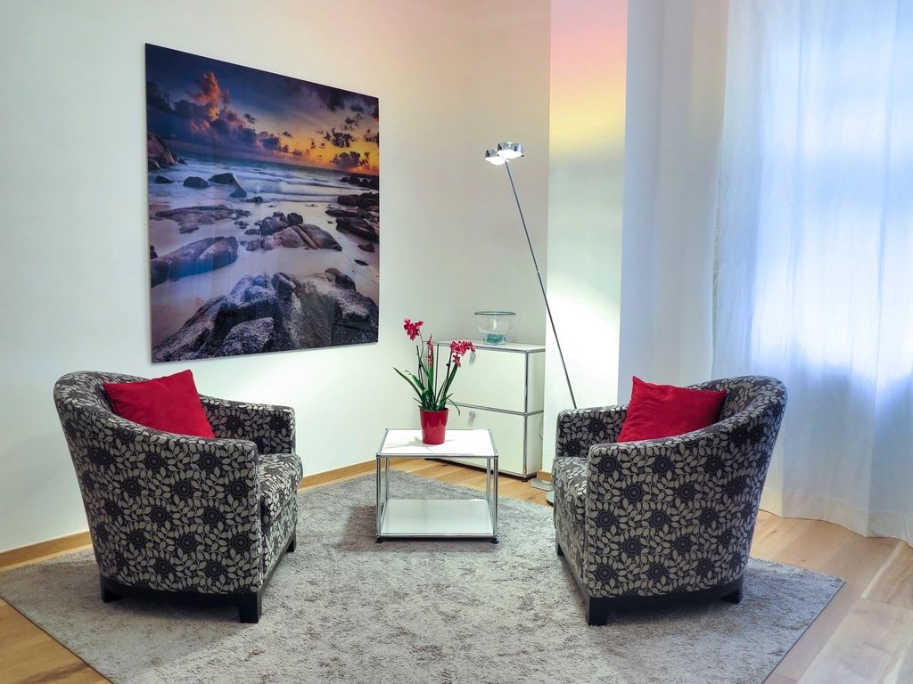 A suite sitting room with a sofa and armchairs